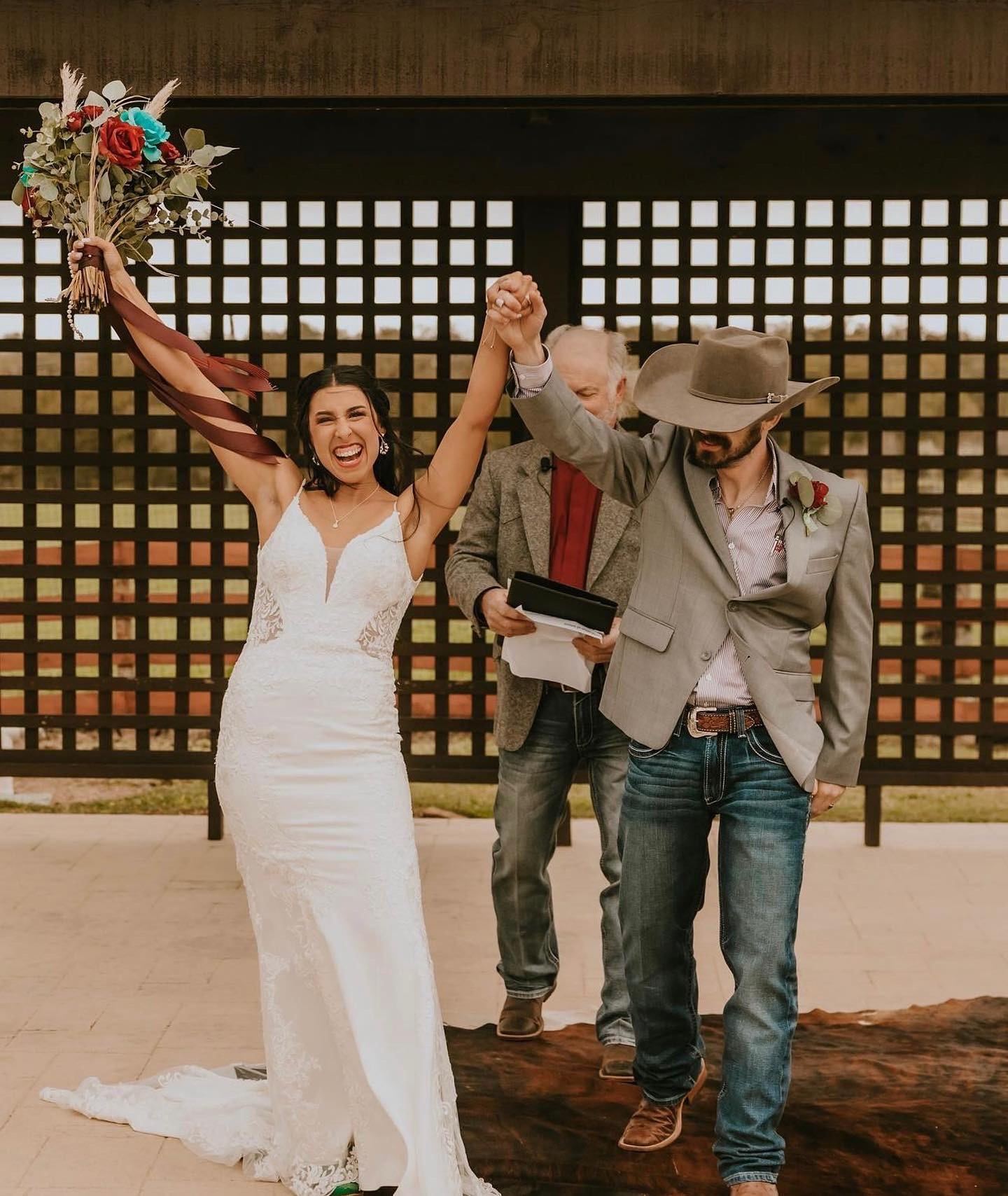 Couple celebrating together beneath the timber pavilion