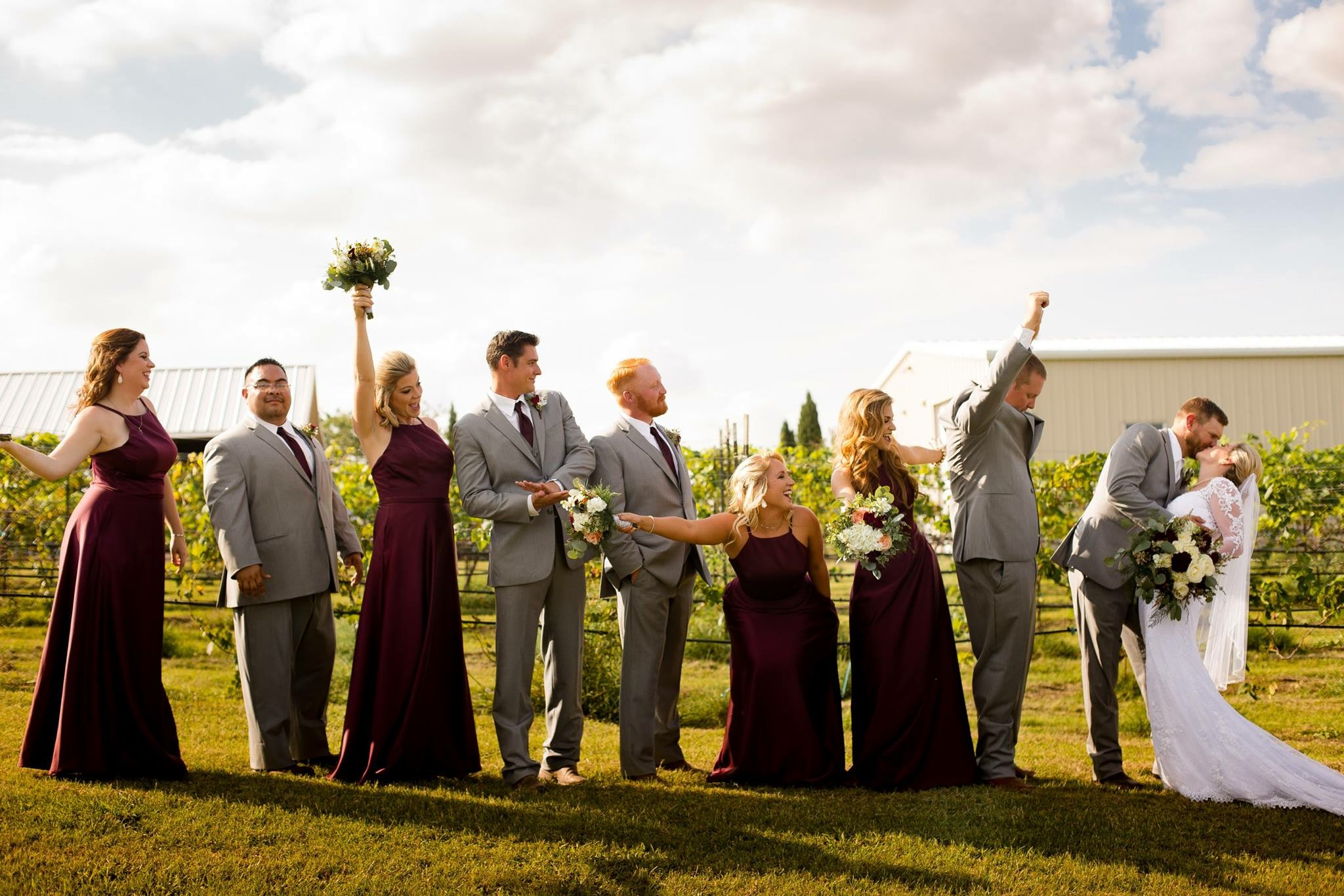 Wedding party standing together outdoors at sunset