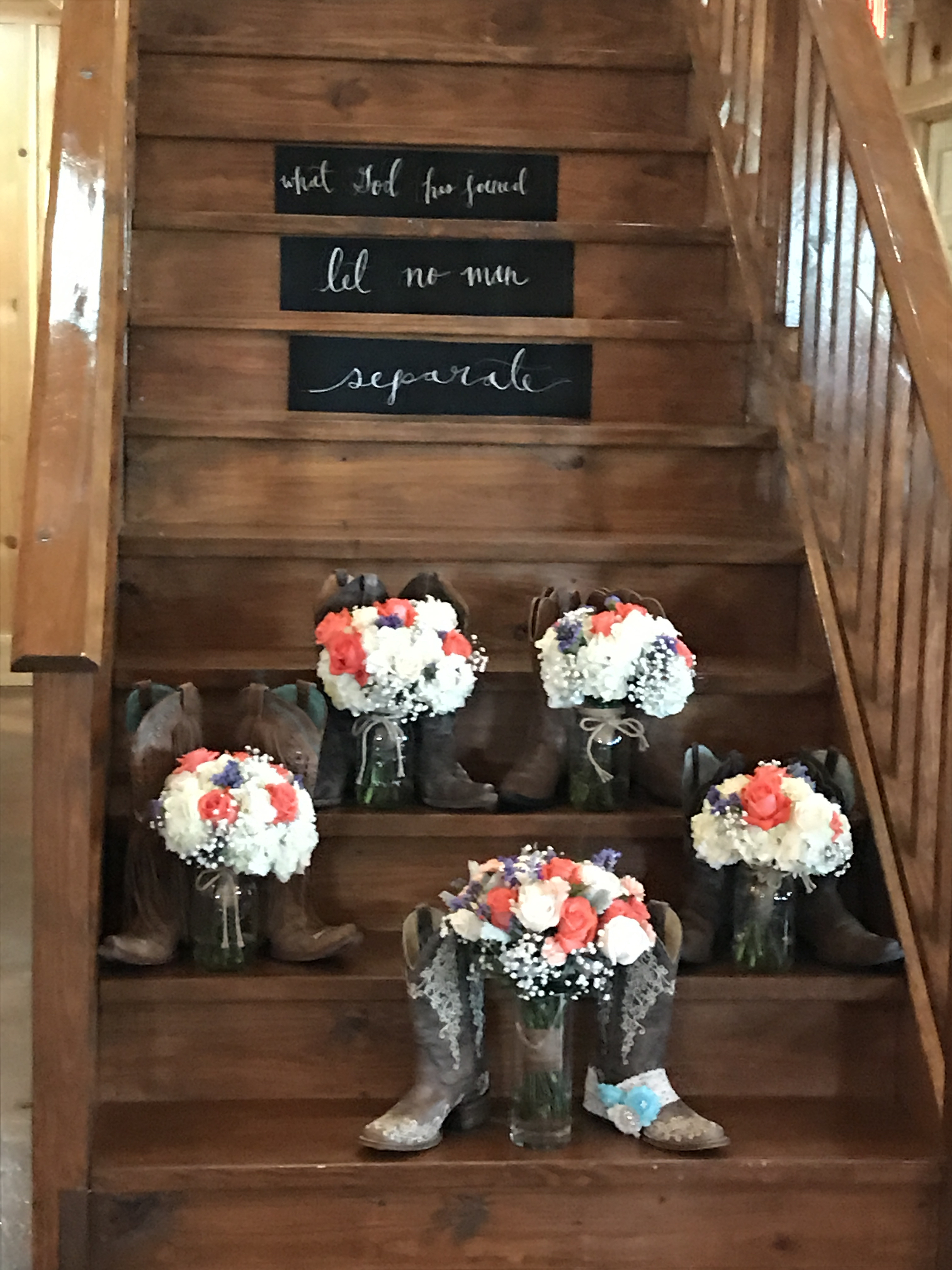 Floral arrangements displayed beneath a welcome sign