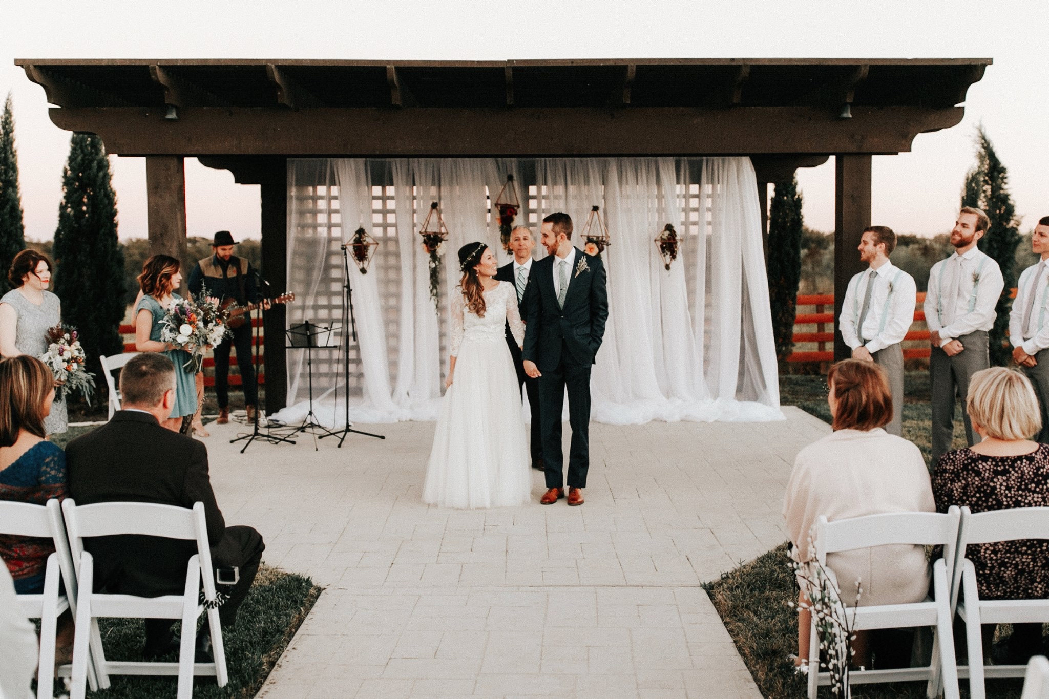 Wedding ceremony beneath the outdoor pavilion